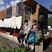 William Gratz left and Claire Boucher sat on their houseboat at the Minneapolis impound lot on Thursday afternoon. The young college students built th