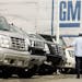 FILE - In this June 1, 2009 file photo, a customer looks at vehicles at a General Motors dealership in Burlingame, Calif. General Motors on Thursday, 