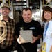 Christine and Steve Deuker met Ryan Newman, center, at the 2009 Daytona 500. Newman held an inscribed brick from the NASCAR Hall of Fame.