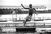 Georgio Harris leaped into the water during swimming time at YMCA Camp Ihduhapi.