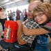 Destany Cleland gave her dad, Eugene, a hug in the Home Depot building after he received a free five-gallon bucket at the State Fair. The Clelands are