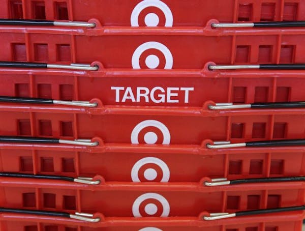 FILE - In this May 20, 2009 file photo, shopping baskets are stacked at a Chicago area Target store. Lean inventory and stronger-than-expected holiday