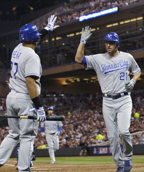 The Royals' Brayan Pena (left) greeted Jeff Francoeur after he scored on a sacrifice fly by Mike Aviles in the fourth inning against the Twins on Tues