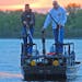 Carl Sassen, left, of Lexington, and Patrick Kirschbaum of Andover prepared to cruise Little Green Lake near Chisago City on Tuesday night, bowfishing