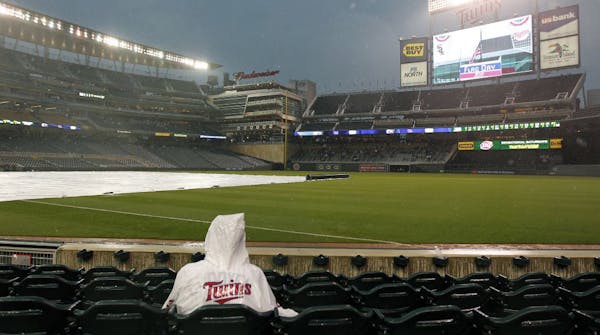 Despite an ominous forecast, the Twins — and their fans, including Austin Manthe, 12, of Lodi, Wis. — held out hope of getting in their game wit