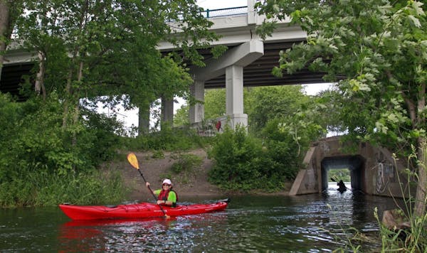The only paddling entrance and exit to Brownie Lake is through a concrete tunnel from Cedar Lake, right. The Cedar Ave. bridge looms overhead.