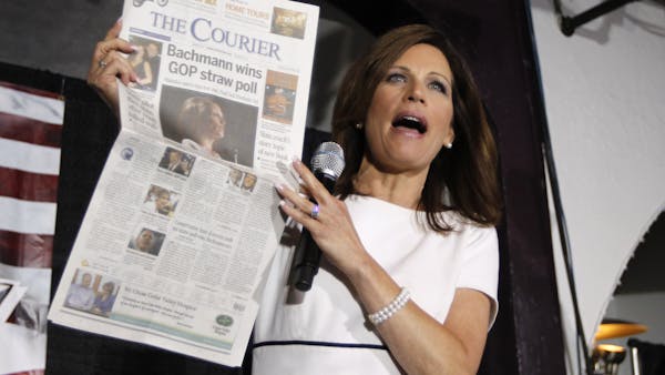 Addressing the Black Hawk County Republican Party Lincoln Day Dinner in Waterloo on Sunday, presidential candidate Michele Bachmann held up a newspape