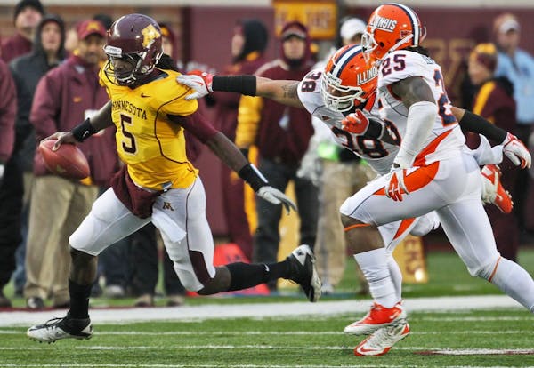 Gophers quarterback MarQueis Gray (5) ran away from Illinois tacklers.