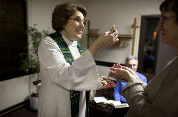 Monique Venne, a priest at Compassion of Christ Church that meets at Prospect Park United Methodist Church, gave communion to Judith McKloskey, also a