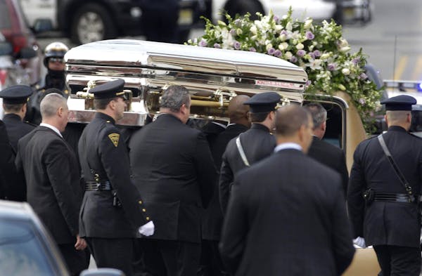 Houston's casket arrives at church for funeral