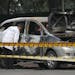 Indian security and forensic officials examine a car belonging to the Israel Embassy after an explosion tore through it, injuring two people in New De