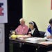 Election volunteers Ed Reeve, left, and Sister Maria Francesca Caldoron, center, worked Tuesday at a polling station at Trinity International Baptist 