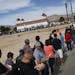 Thousands of people wait in line to buy tickets for the Mega Millions Lottery jackpot at the Primm Valley Casino Resorts Lotto store in California nea