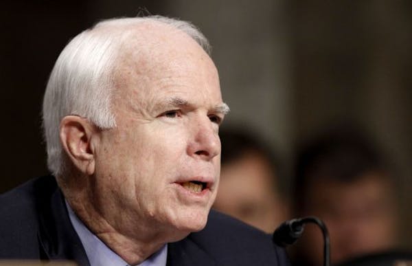 McCain defends Clinton aide