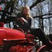 Atina Diffley posed for a portrait Tuesday, April 10 on her husband's International Harvest 140 tractor at their farm in Farmington. Her new book, “