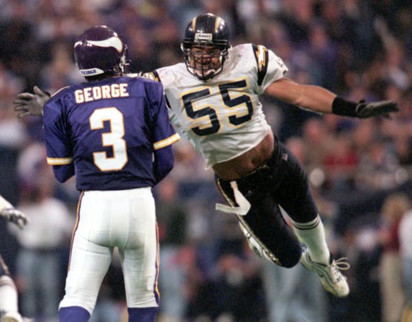 Vikings vs. San Diego Chargers November 28, 1999 -- San Diego Chargers linebacker Junior Seau, #55, tries to get to Minnesota Viking quarterback Jeff 