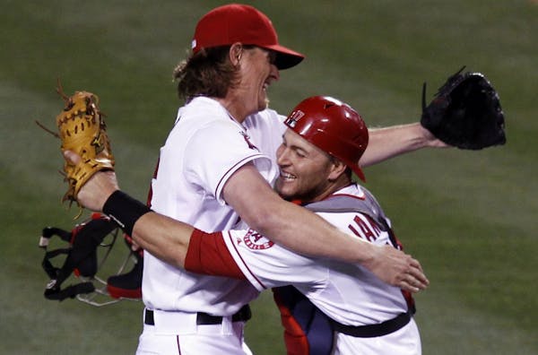 Angels starting pitcher Jered Weaver celebrated his no-hitter against the Twins with catcher Chris Iannetta on Wednesday night.