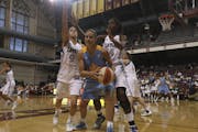 Chicago Sky's Ticha Penicheiro was double teamed by new Lynx players Queralt Casas, left, and Devereaux Peter during an exhibition game at the Univers