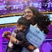 With confetti falling, Snigdha Nandipati, 14, of San Diego, right, is embraced by her brother Sujan Nandipati, 10, after she won the National Spelling