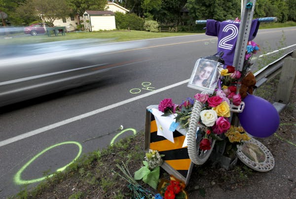 Cars on Hwy. 101 passed by a memorial for Aimee Trudeau near Sandy Hook Road in Chanhassen. The 12-year-old died late Wednesday after she was hit by a