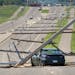 Strong winds splintering wooden power poles on Pilot Knob Road in Apple Valley closing down traffic between County Roads 42 and 46 Tuesday, June 19, 2