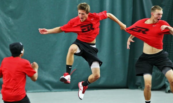 Elk River tennis players Steven Delain, center, and Mitch Brandell, right, whooped it up after clinching a 5-2 Class 3A title victory over Wayzata on 