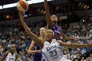 Minnesota's Maya Moore scored over Phoenix's DeWanna Bonner during Sunday's WNBA game.