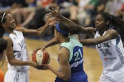 Lynx reserves Candice Wiggins, left, and Devereaux Peters tried to strip the ball from New York's Alex Montgomery after she grabbed a third-quarter re