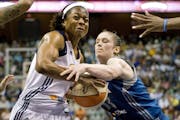 Connecticut Sun's Danielle McCray, left, is pressured by Minnesota Lynx' Lindsay Whalen during the second half of a WNBA basketball game in Uncasville