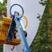 Workmen take down an Olympic flag in the Mall near Buckingham Palace in London, Monday Aug. 13, 2012, following the closing ceremony of the 2012 Summe