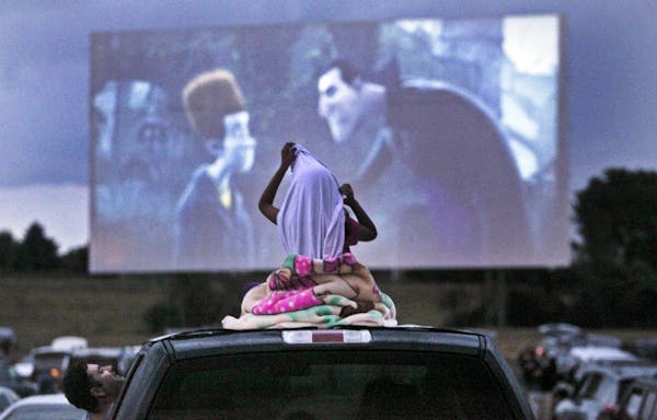 A young movie viewer got comfortable atop the family’s vehicle for the double feature of “Ice Age: Continental Drift” and “Brave” at the Cot