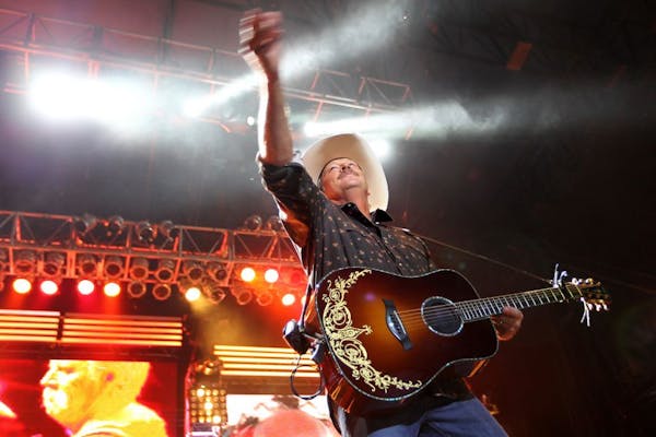 Alan Jackson threw guitar picks and t-shirts to the crowd as he performed at the Minnesota State Fair August 24, 2012.