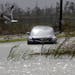 A car sits stranded in rising floodwaters from Isaac, which is expected to make landfall in the region as a hurricane this evening in Venice, La., the