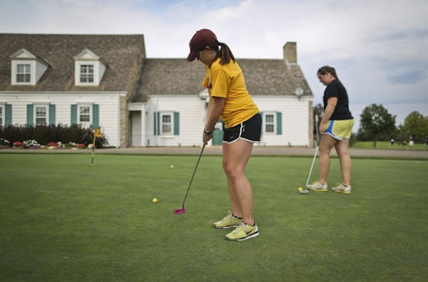 University of Minnesota senior Paige Schneider putted during a golf class at the Les Bolstad Golf Course, joined by senior Marissa Klabunde.