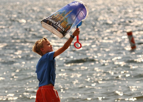Kite walker, Joseph Anderson 7 years old of Plymouth, Minn. walked on the shore of Wayzata Bay with an improvised kite made from a plastic bag and a s