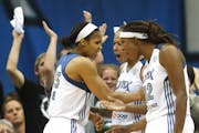Lynx stars Maya Moore, Seimone Augustus and Rebekkah Brunson celebrated after Moore blocked a shot by former Lynx star Katie Smith during the second h
