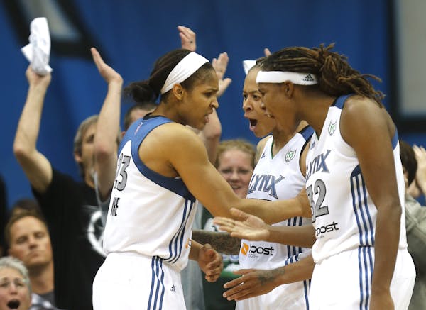 Lynx stars Maya Moore, Seimone Augustus and Rebekkah Brunson celebrated after Moore blocked a shot by former Lynx star Katie Smith during the second h