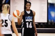 Devereaux Peters, the first-round draft pick, No. 3 overall, for the defending WNBA champion Lynx, shares a laugh with teammate Brittany Rayburn, left