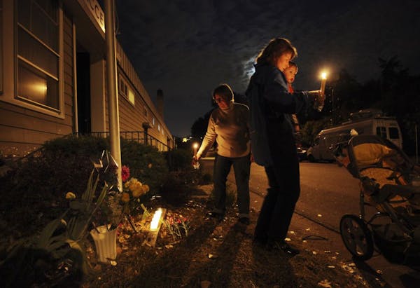 Dorothy Rice, left, who lives a few houses from the homicide scene, was joined by her daughter Cynthia Parson, right, and son Lakota, 1 1/2, outside A