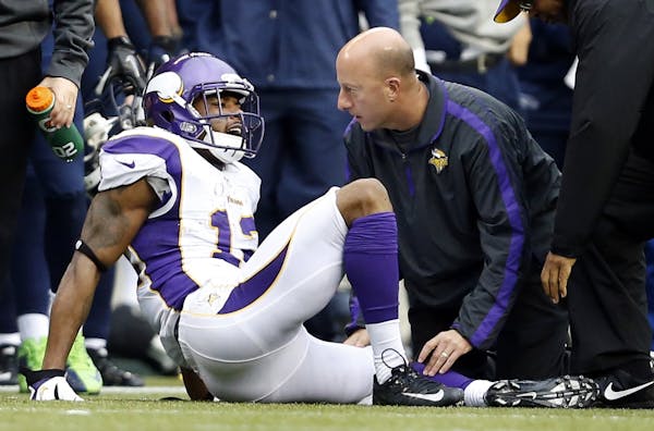 Head athletic trainer Eric Sugarman attended to Vikings receiver Percy Harvin during the third quarter in Seattle.