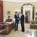 A handout photograph of President Barack Obama shaking hands with former Massachusetts Gov. Mitt Romney in the Oval Office of the White House before a