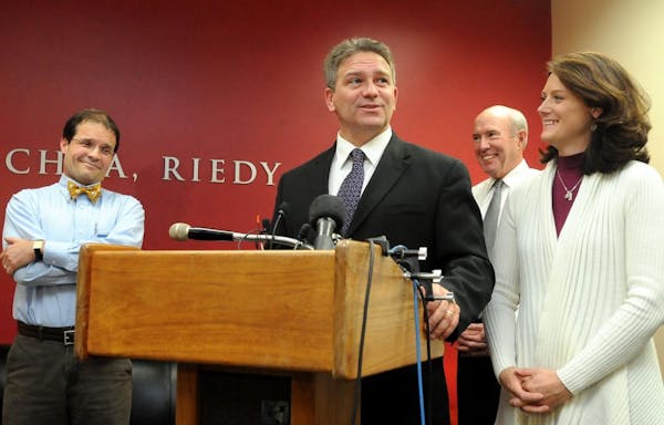 Todd Hoffner speaks to reporters as his wife, Melodee, right, attorneys Jim Fleming, left, and Gerald Maschka, second left, listen, Friday, Nov. 30, 2