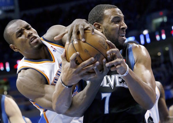 Oklahoma City Thunder forward Serge Ibaka, left, and Minnesota Timberwolves forward Derrick Williams (7) fight for control of the ball in the second q