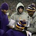 Vikings quarterback Christian Ponder looked a game photos on the sideline with starting quarterback Joe Webb at Lambeau Field in Green Bay, Wisc.