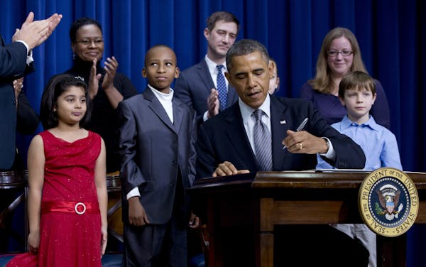 President Barack Obama, accompanied by Vice President Joe Biden, standing left clapping, and children who wrote the president about gun violence follo