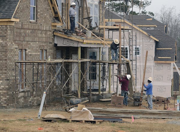 Construction crews build new homes in Waxhaw, N. C., just one sign that the housing industry is on the upswing.
