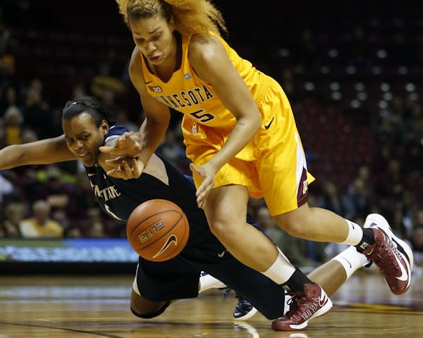 Talia East of Penn State tries to steal the ball from Micaella Riche of the Gophers.