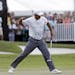 Tiger Woods pumps his fist after making birdie putt on the 18th hole during the third round of the Cadillac Championship golf tournament Saturday, Mar