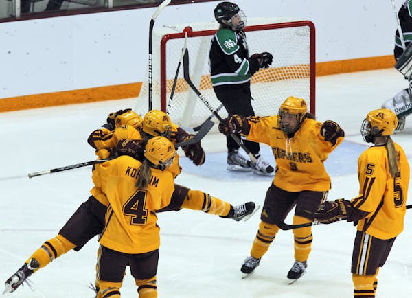 Gophers women's hockey players celebrate a goal, which turned out to be disallowed, during Saturday's WCHA Final Faceoff victory over North Dakota. Th