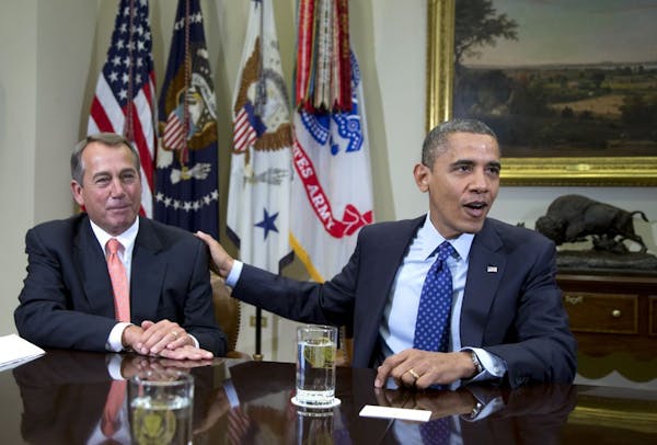 President Barack Obama acknowledges House Speaker John Boehner of Ohio while speaking to reporters in the Roosevelt Room of the White House in Washing